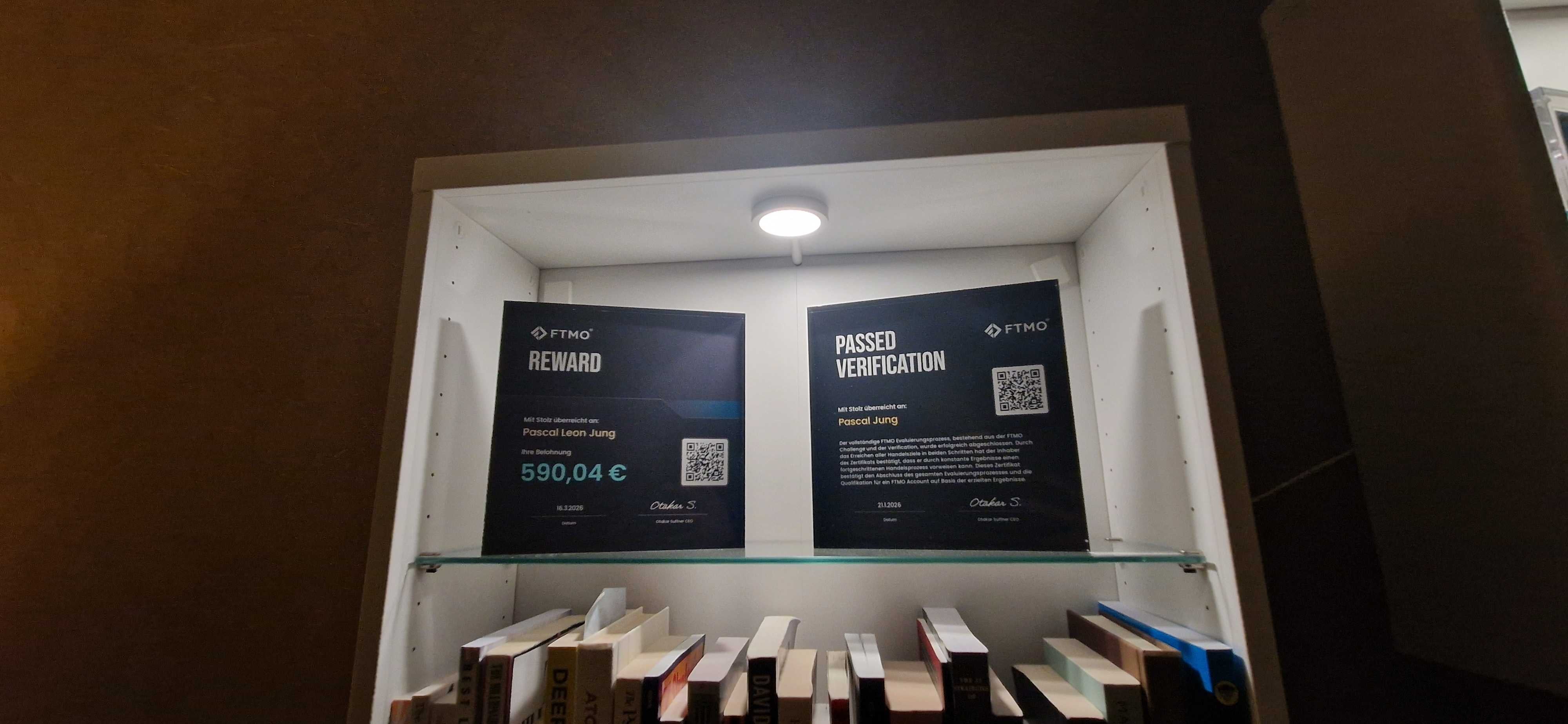 Two Funded Award acrylic plaques side by side, each displaying an FTMO funded trader certificate