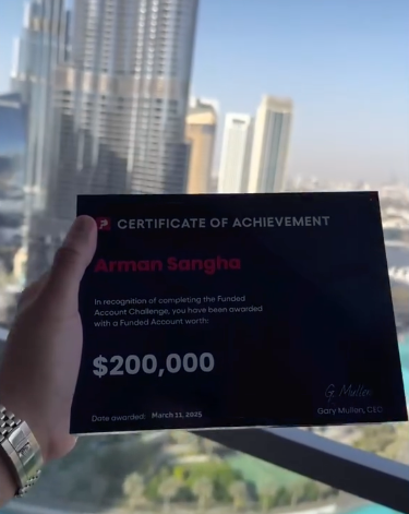 Hand holding a funded certificate of achievement with Dubis cityscape in the background