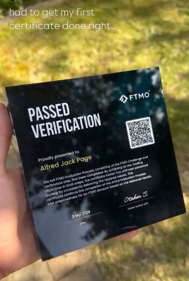 A Funded Award of passed verification from FTMO prop firm held by a person with a blurred natural background