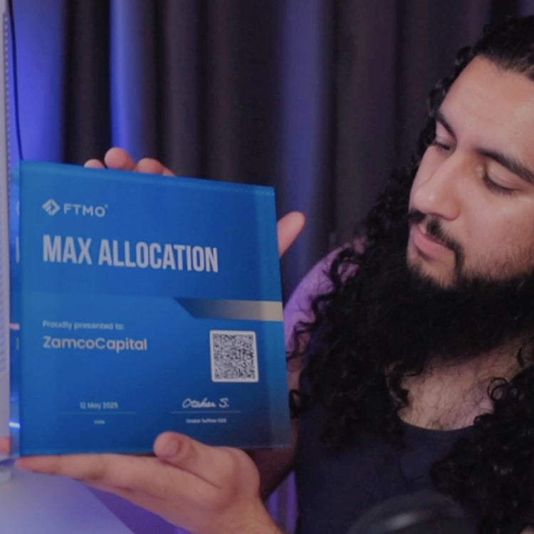 Person holding a FTMO funded award 'MAX ALLOCATION'certificate with a QR code on a dark background